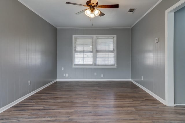 empty room featuring ornamental molding, dark wood-type flooring, and ceiling fan