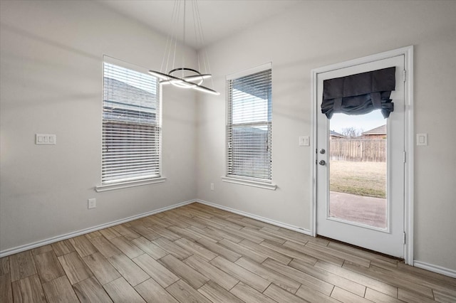 interior space featuring an inviting chandelier and light hardwood / wood-style floors