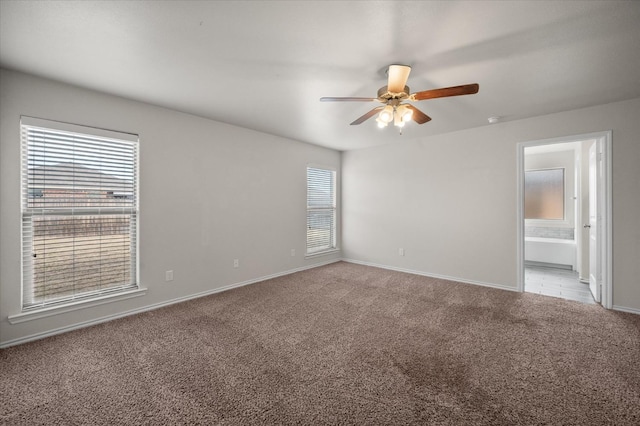 spare room featuring ceiling fan and light carpet