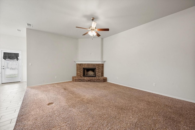 unfurnished living room with ceiling fan, a fireplace, and carpet floors