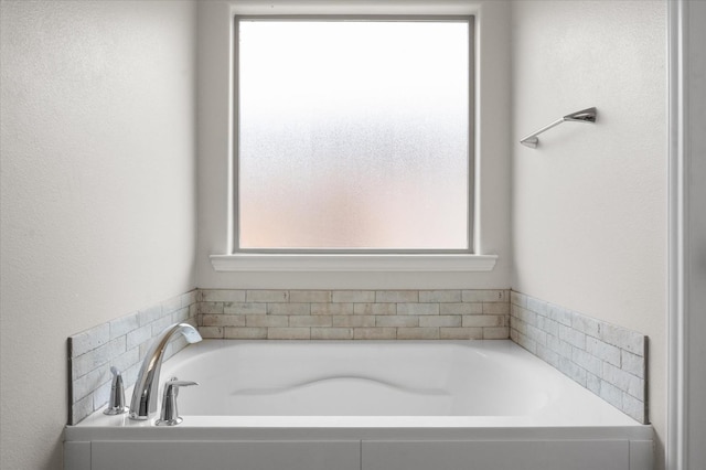 bathroom featuring a wealth of natural light and a tub