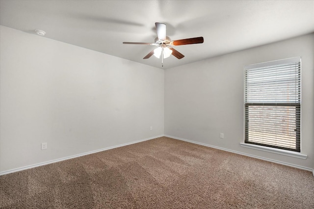 carpeted empty room featuring ceiling fan