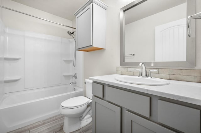 full bathroom with vanity, wood-type flooring, bathtub / shower combination, and toilet