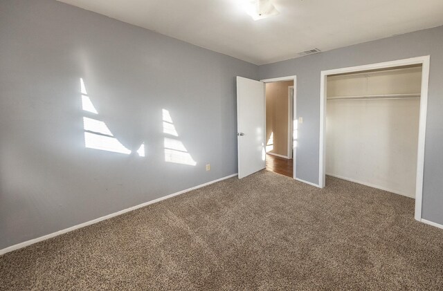 unfurnished bedroom with a closet and carpet