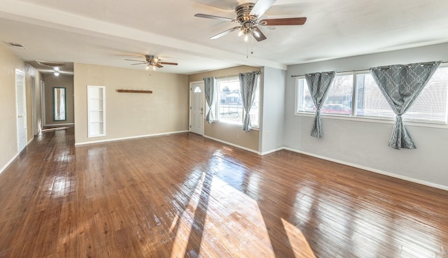 empty room with ceiling fan and dark hardwood / wood-style floors