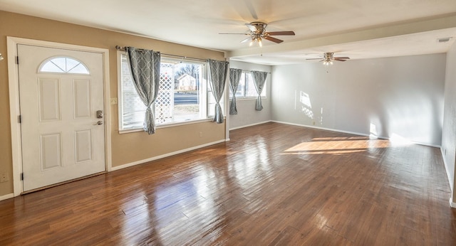 foyer entrance featuring dark wood-type flooring and ceiling fan