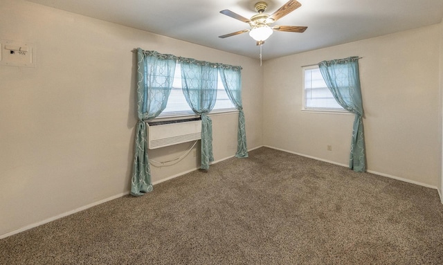 spare room with ceiling fan and dark colored carpet