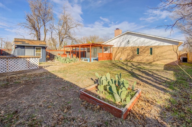 view of yard with central AC unit and a storage shed