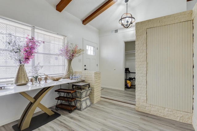 interior space featuring high vaulted ceiling, beam ceiling, a chandelier, and light hardwood / wood-style floors