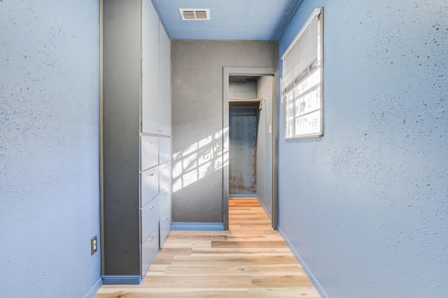 corridor with light wood-type flooring