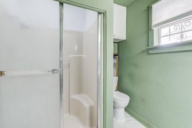 bathroom with toilet and walk in shower