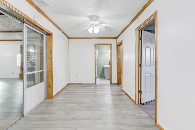 corridor with ornamental molding and light wood-type flooring