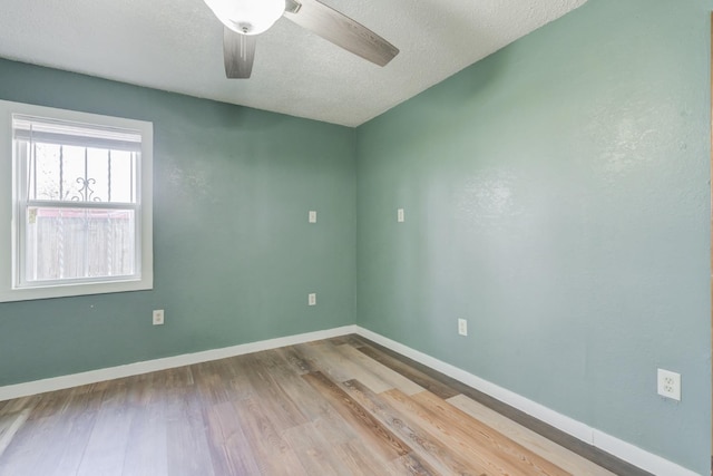 spare room featuring hardwood / wood-style floors, a textured ceiling, and ceiling fan