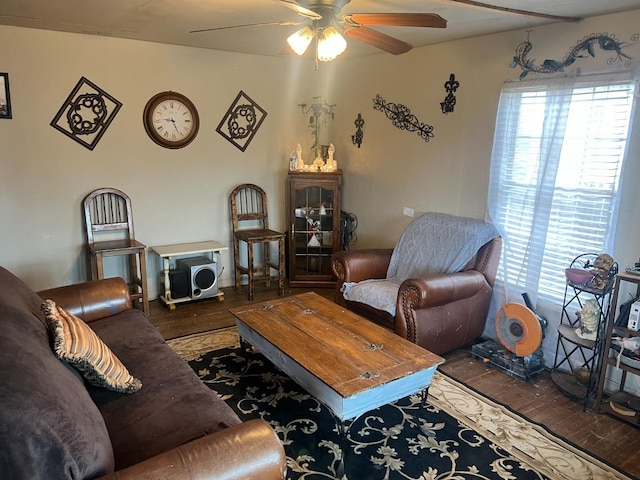 living room with ceiling fan and dark hardwood / wood-style flooring