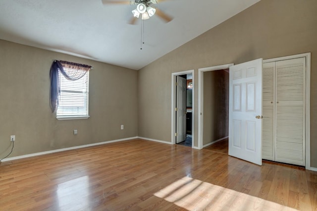 unfurnished bedroom with vaulted ceiling, ceiling fan, connected bathroom, and light hardwood / wood-style floors