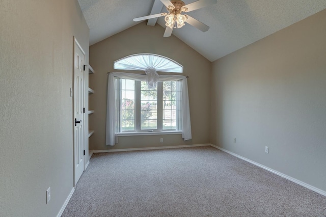 unfurnished room featuring light carpet, a textured ceiling, vaulted ceiling, and ceiling fan