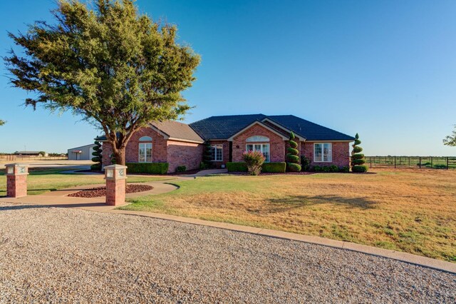 ranch-style house with a front lawn