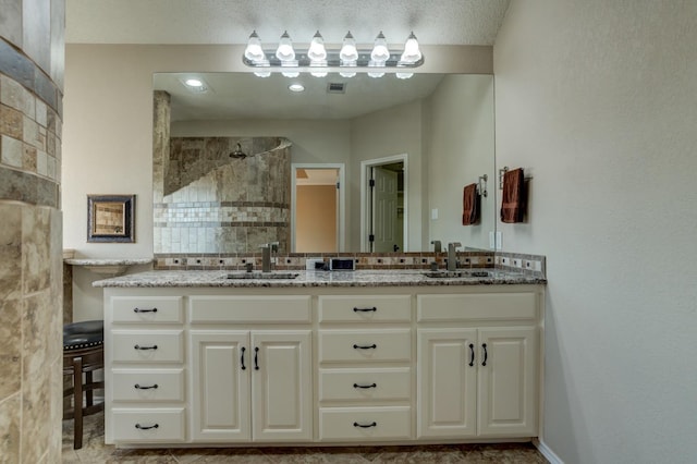 bathroom with a shower and vanity