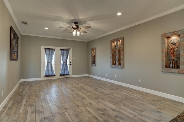 spare room featuring crown molding, light hardwood / wood-style flooring, ceiling fan, a textured ceiling, and french doors