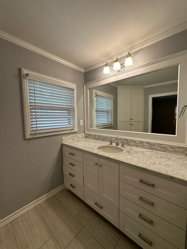 bathroom with crown molding and vanity