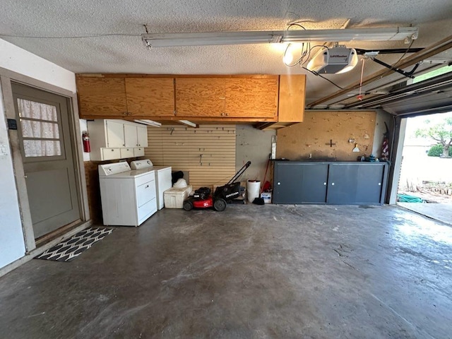 garage with a garage door opener and washing machine and dryer