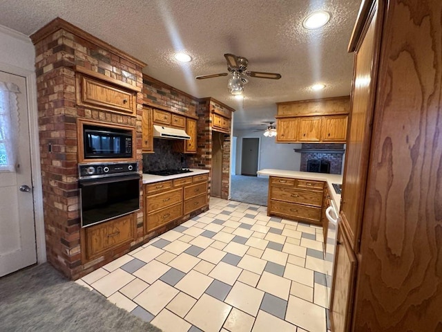 kitchen with ceiling fan, ornamental molding, a textured ceiling, and black appliances