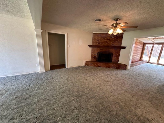 unfurnished living room with a fireplace, ornamental molding, a textured ceiling, and carpet