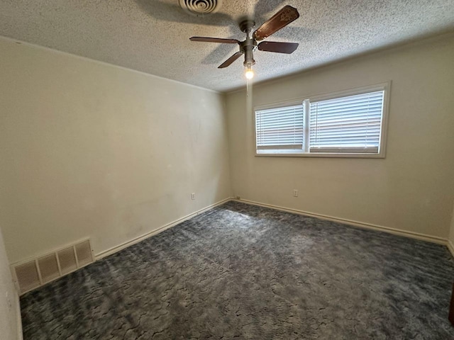 carpeted spare room with ceiling fan and a textured ceiling