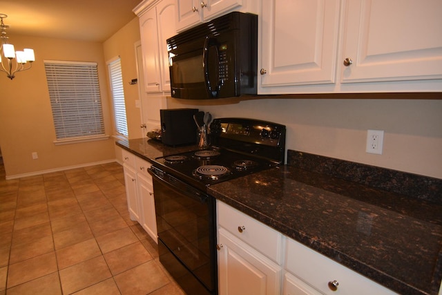 kitchen with white cabinetry, decorative light fixtures, a chandelier, dark stone countertops, and black appliances