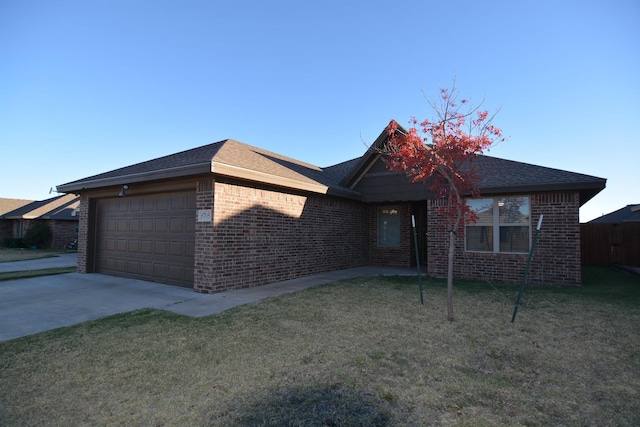 view of front of home featuring a garage and a front lawn