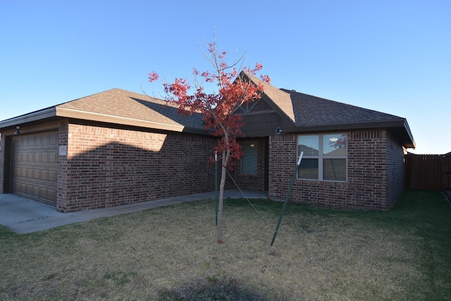 ranch-style home featuring a garage and a front lawn