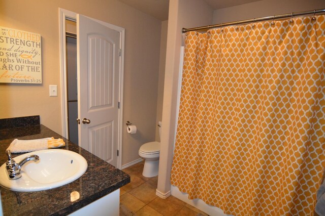 bathroom with vanity, toilet, and tile patterned flooring