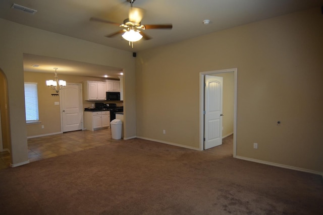 unfurnished living room with light colored carpet and ceiling fan with notable chandelier