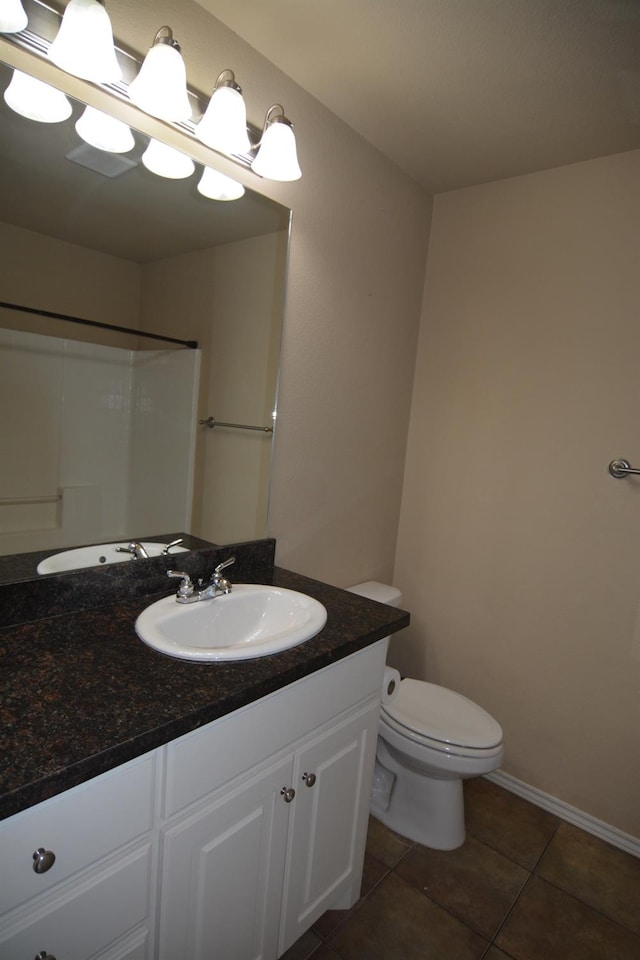 bathroom featuring tile patterned flooring, vanity, and toilet