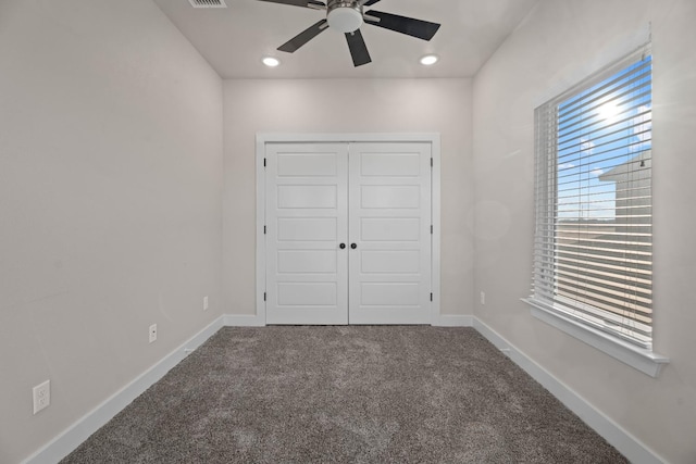 unfurnished bedroom with ceiling fan, carpet floors, and a closet