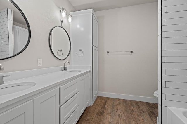 full bathroom with vanity, plus walk in shower, hardwood / wood-style floors, and toilet