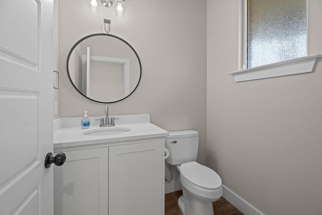 bathroom with vanity, toilet, and wood-type flooring