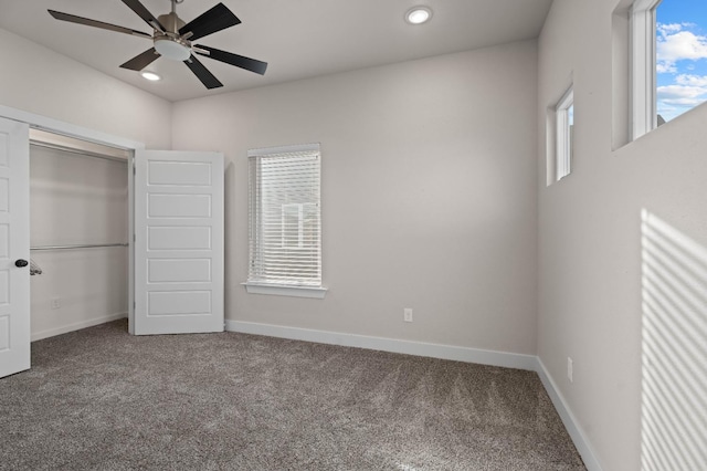 unfurnished bedroom with multiple windows, carpet floors, and a closet