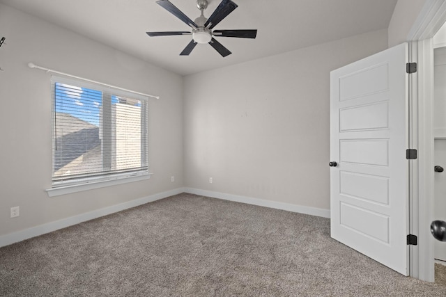 spare room featuring light colored carpet and ceiling fan