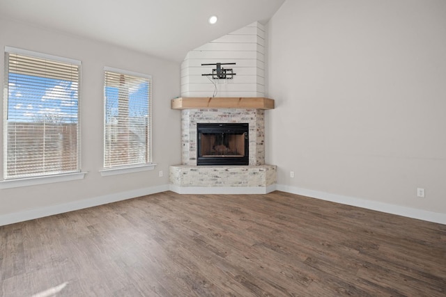 unfurnished living room with vaulted ceiling and wood-type flooring