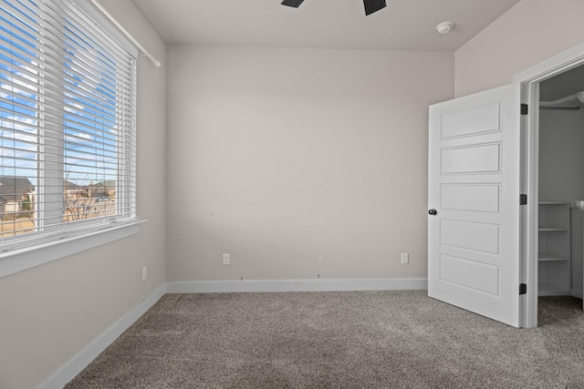 unfurnished bedroom featuring ceiling fan and carpet