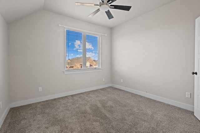 spare room with vaulted ceiling, ceiling fan, and carpet flooring