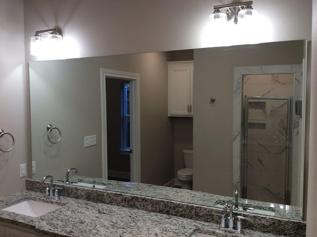 bathroom featuring walk in shower, vanity, and toilet