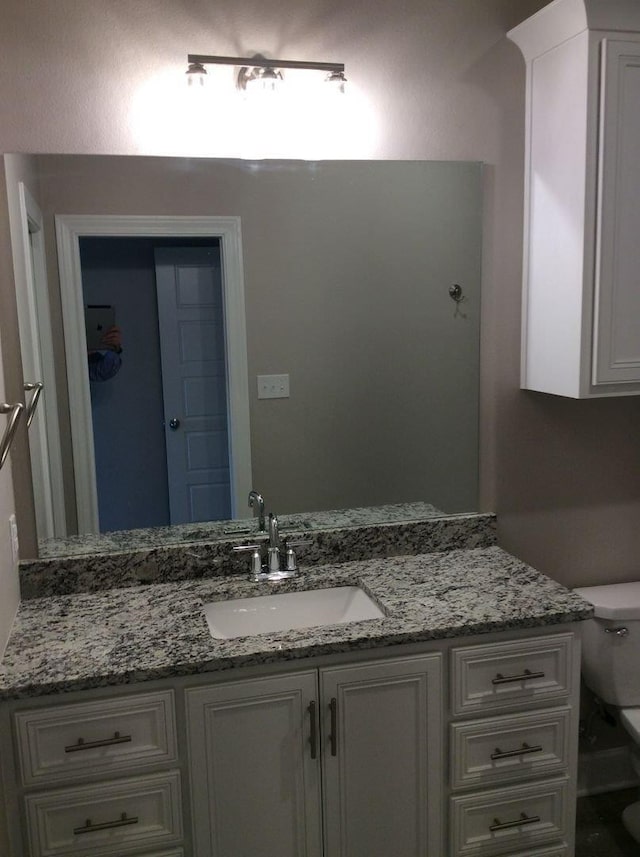 bathroom featuring vanity and toilet