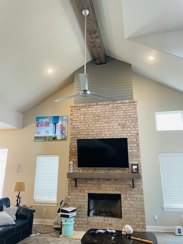 living room with hardwood / wood-style flooring, a fireplace, and lofted ceiling with beams