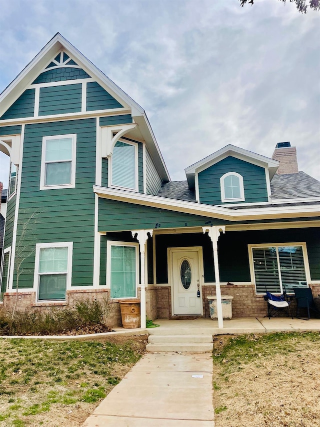 view of front of house with a front yard and covered porch