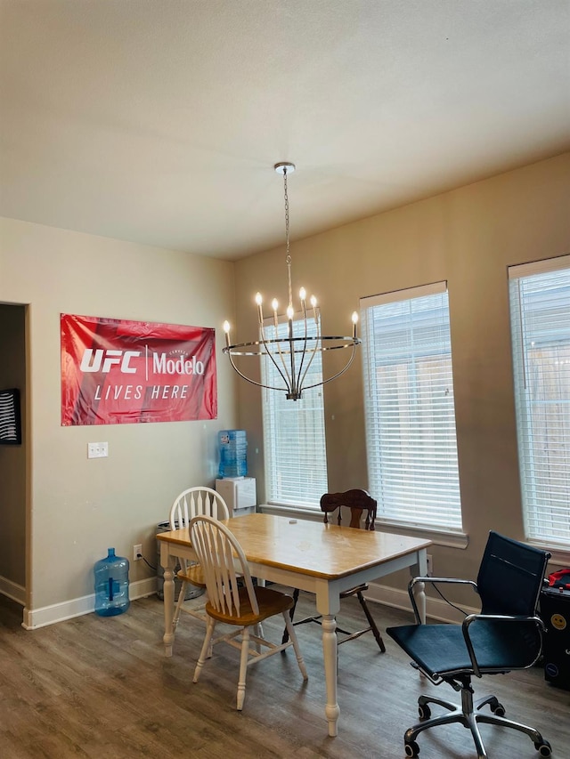 dining space with hardwood / wood-style flooring and a chandelier