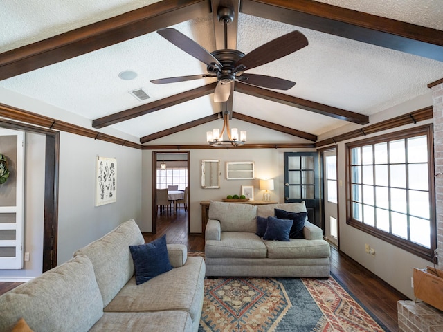 living area featuring a ceiling fan, vaulted ceiling with beams, wood finished floors, and a textured ceiling