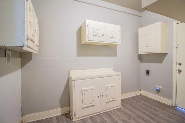 laundry room with wood-type flooring and hookup for an electric dryer