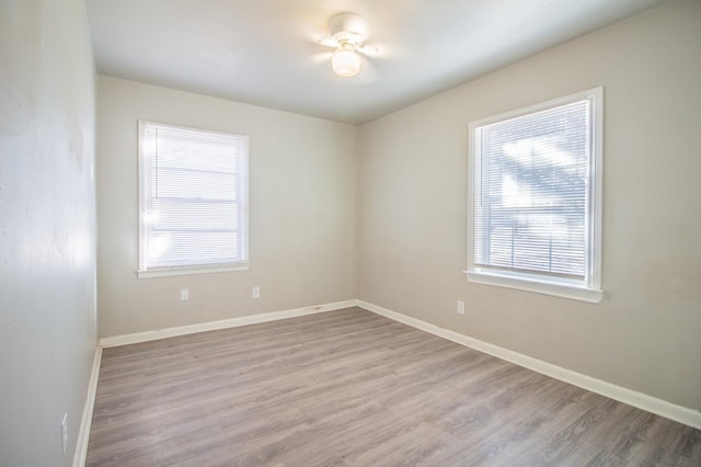 unfurnished room featuring plenty of natural light and light wood-type flooring